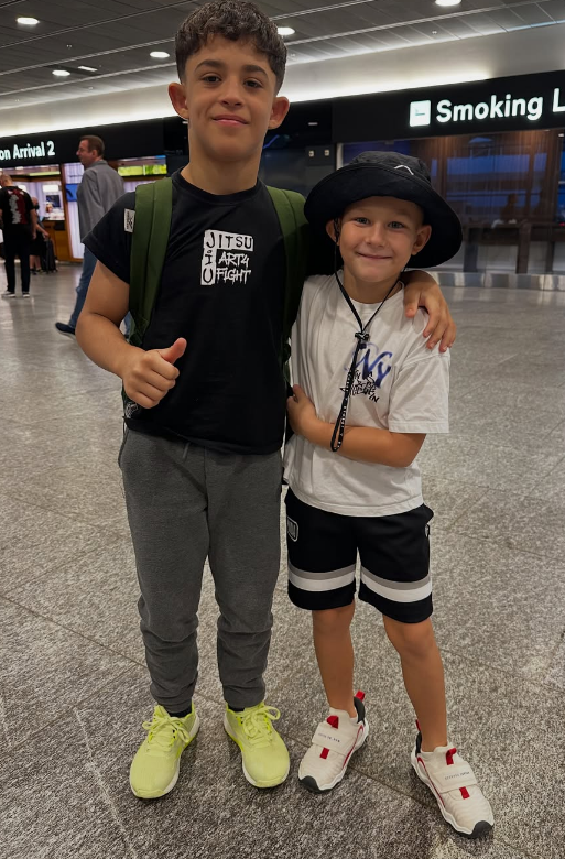 Izzy Cheli'oss with a teammate at the airport
